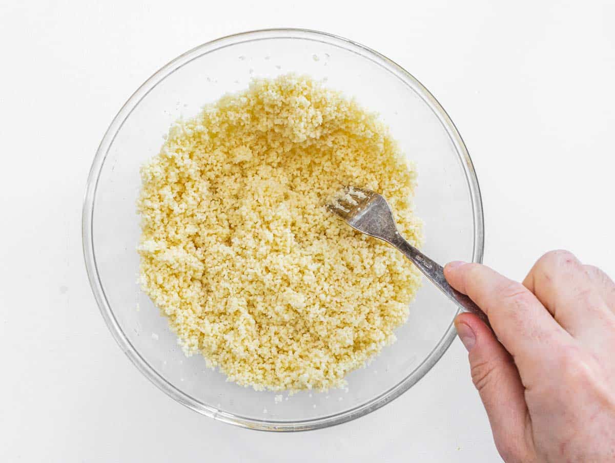 Couscous with fork and hands