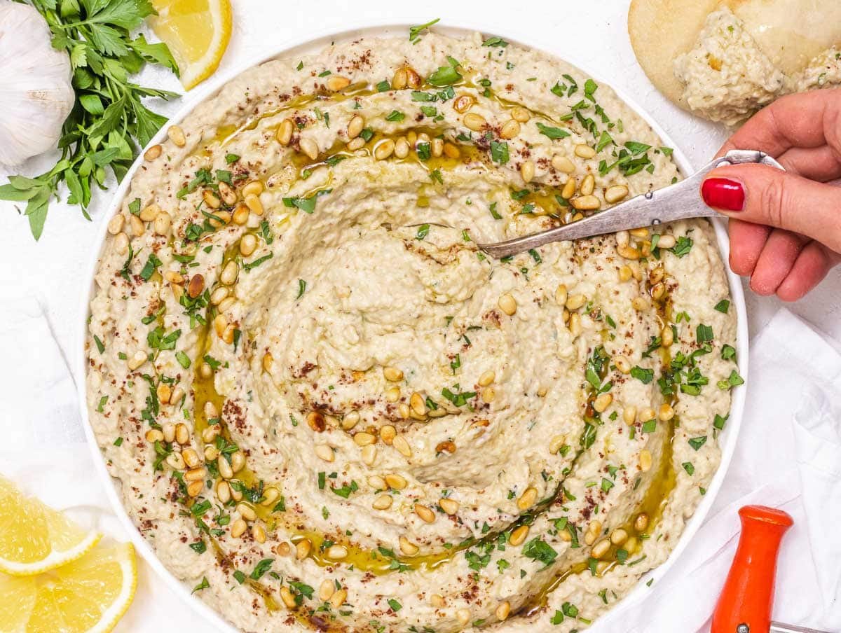 Mutabal with spoon and hand