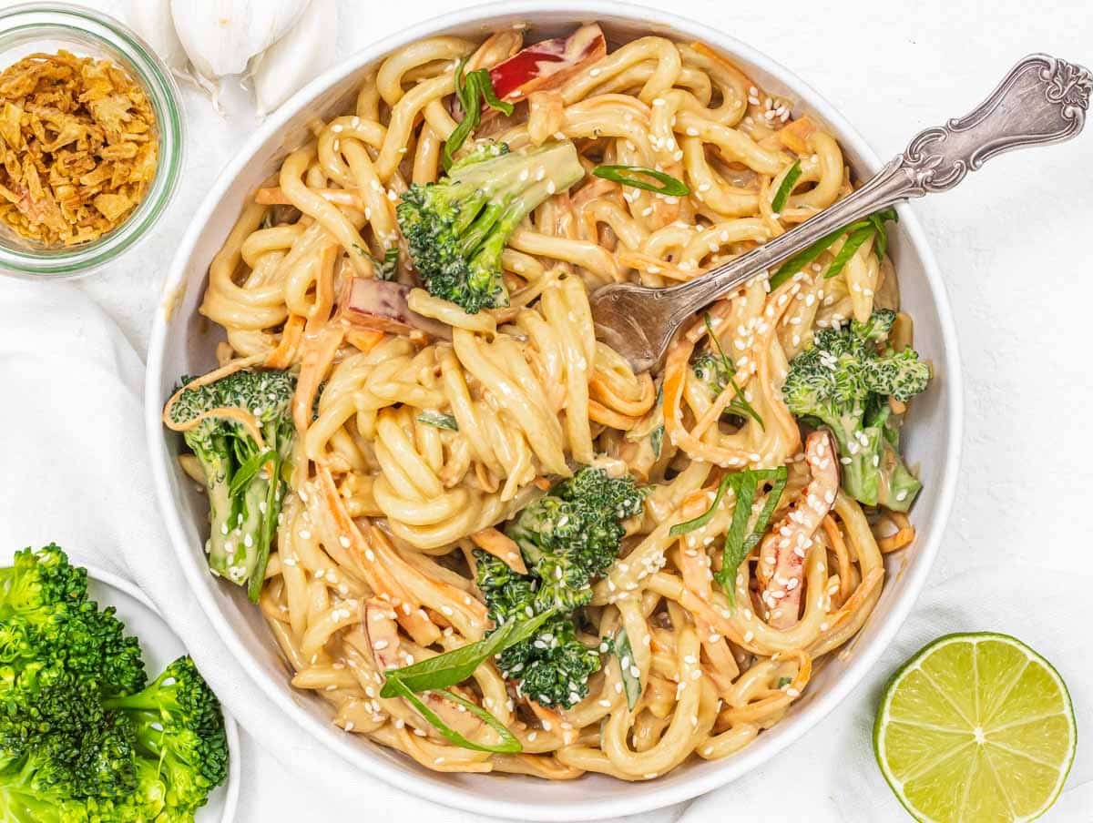 Peanut noodles with broccoli and fork