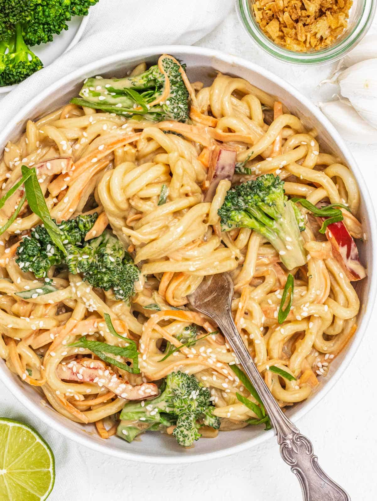 Peanut noodles with broccoli and silver fork