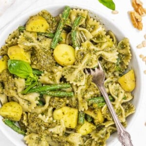 fork with pesto pasta and potatoes