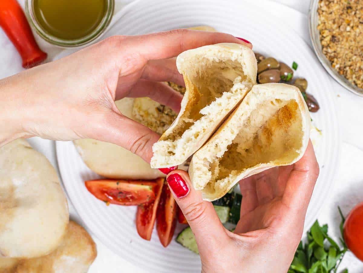 Pita bread with hands and red nails