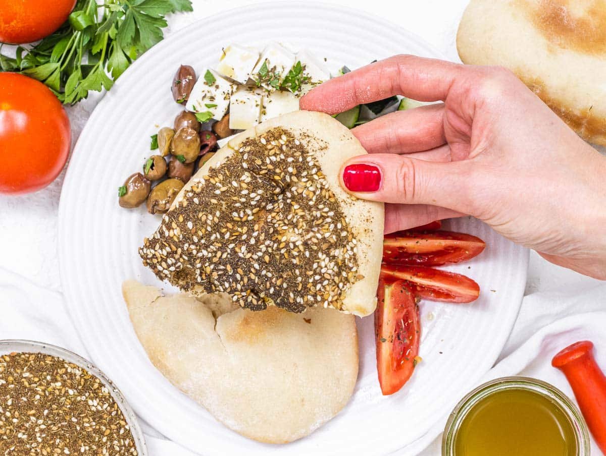 Pita bread with hand and red nails