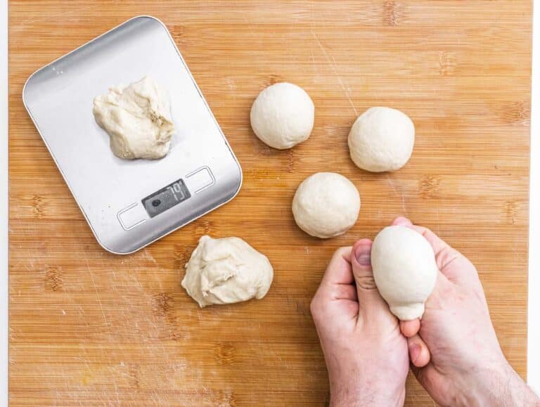 hands shaping small dough balls