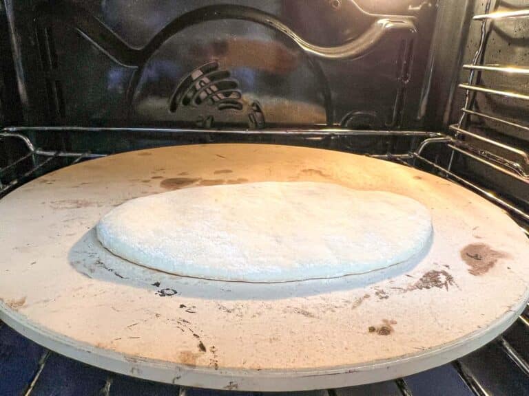 Pita dough baking on a pizza stone