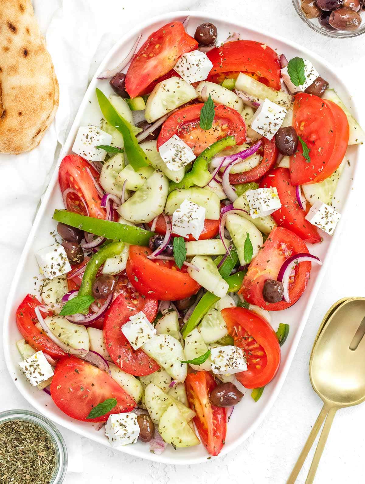 Greek cucumber salad on a white platter