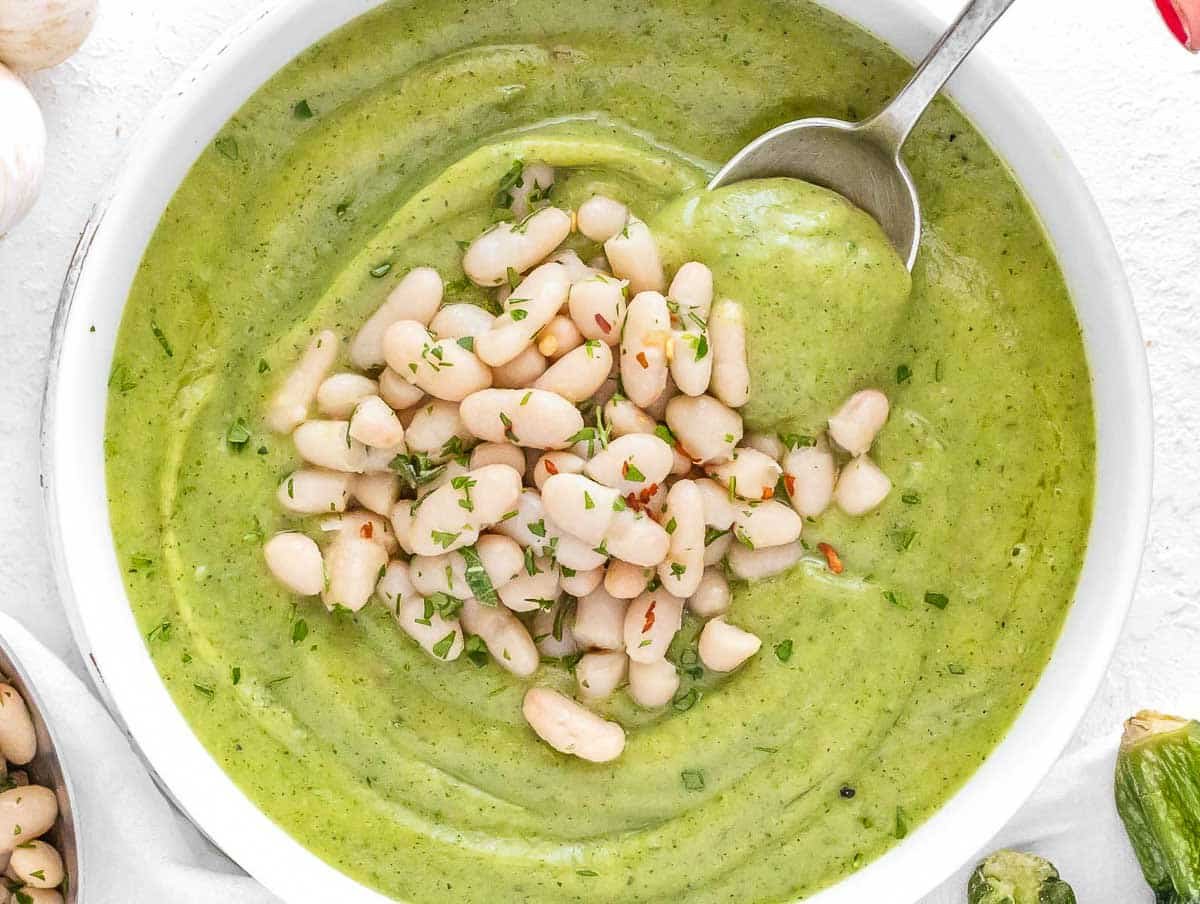 Zucchini soup with beans and a spoon
