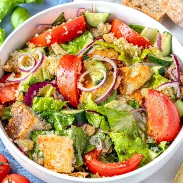 panzanella salad with bread, vine tomatoes, and romaine lettuce in a bowl