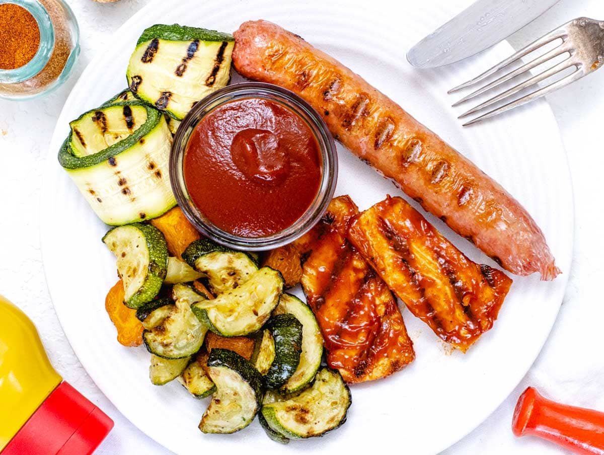 BBQ sauce with vegetables and a sausage