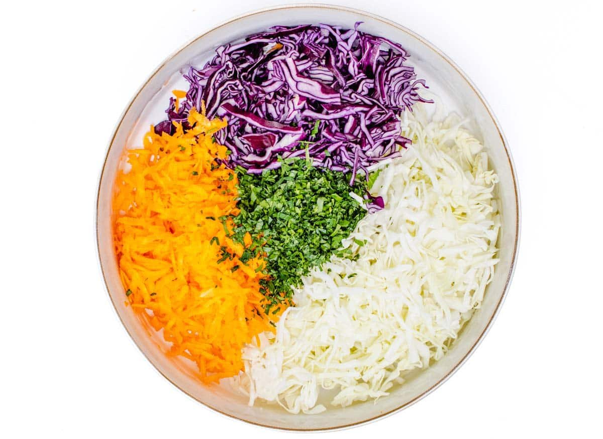 carrot, red cabbage and green cabbage in a bowl