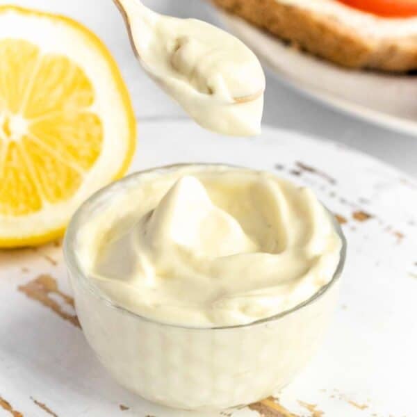 Creamy vegan mayonnaise with a spoon.