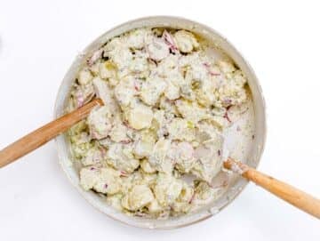 Mixing potato salad in a big bowl