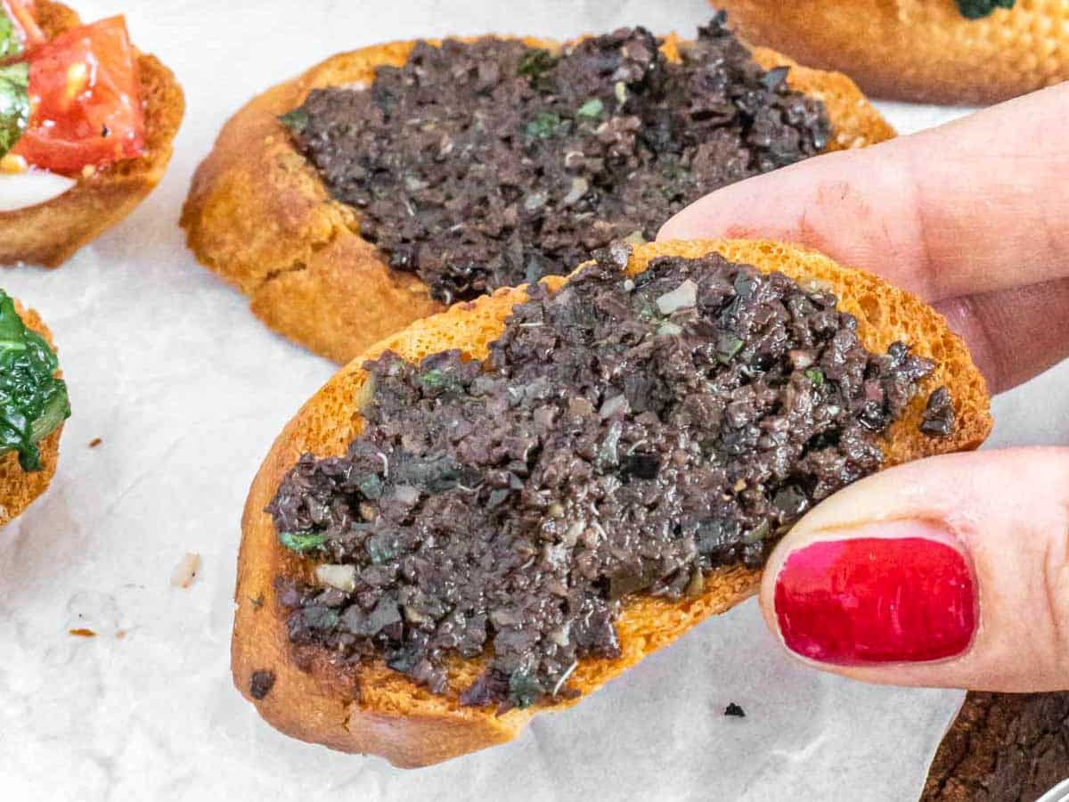 Olive tapenade crostini and hand