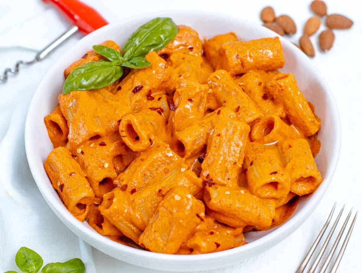 Red Pepper Pasta is a bowl with basil