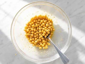Step 1 Mixing olive oil, lemon juice, mustard, honey, garlic, oregano, and chickpeas.