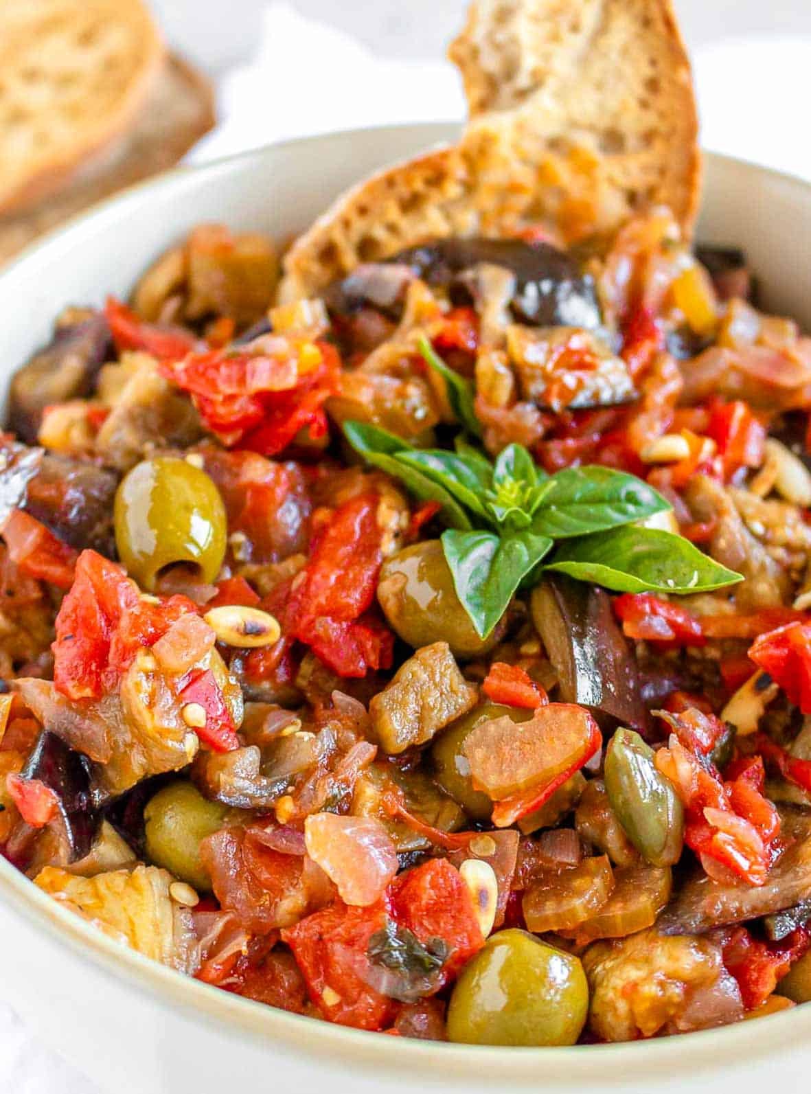 Caponata in a bowl with basil