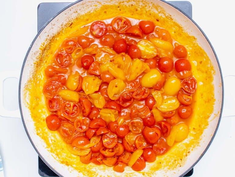 Cooked cherry tomatoes in a skillet