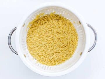 cooked orzo in a white sift