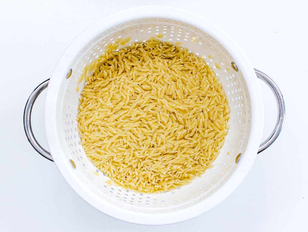 cooked orzo in a white sift