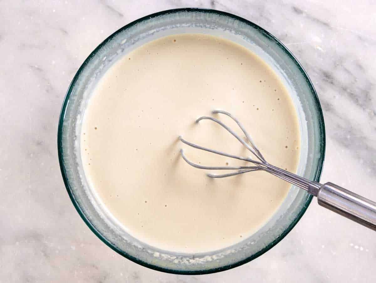 Tahini sauce after whisking and served in a glass bowl
