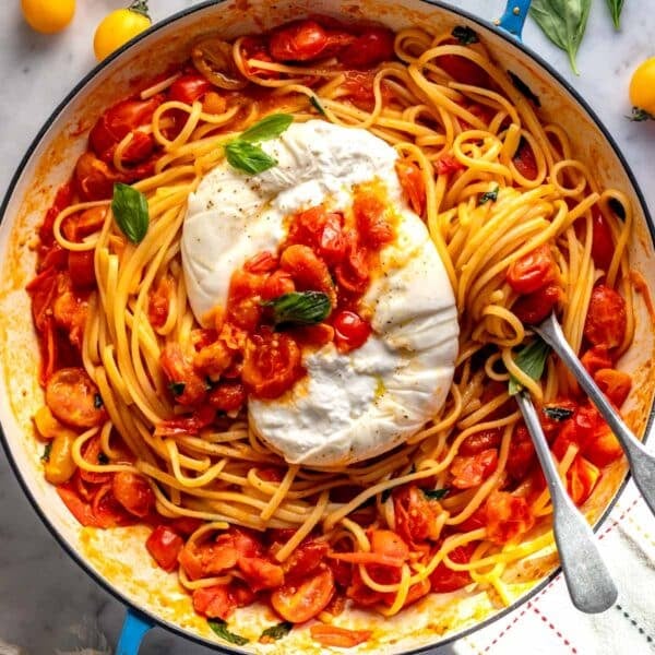 cherry tomato pasta with burrata in a blue skillet.