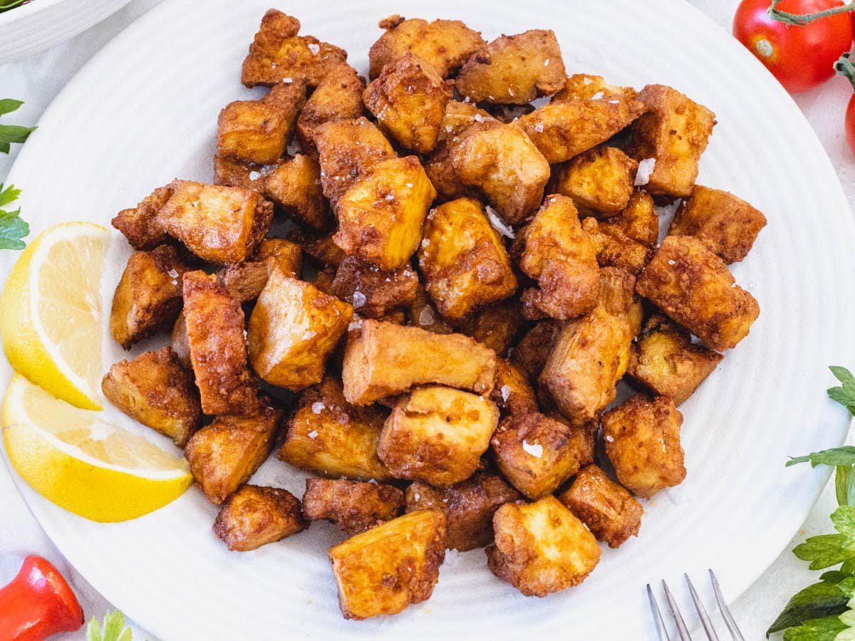 Air fryer tofu on a plate with salt flakes