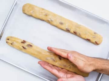 hands shaping long biscotti dough