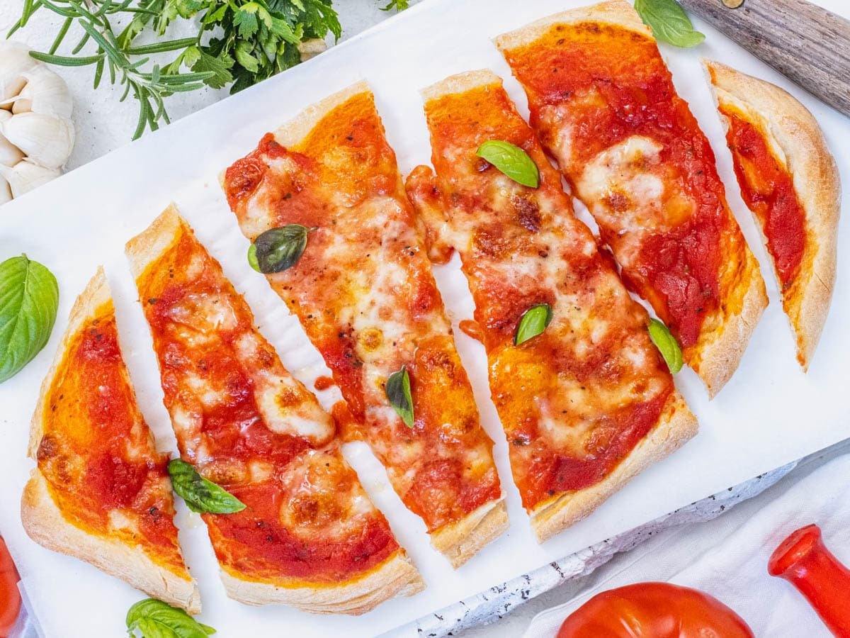 Flatbread pizza with canned tomatoes and melted cheese