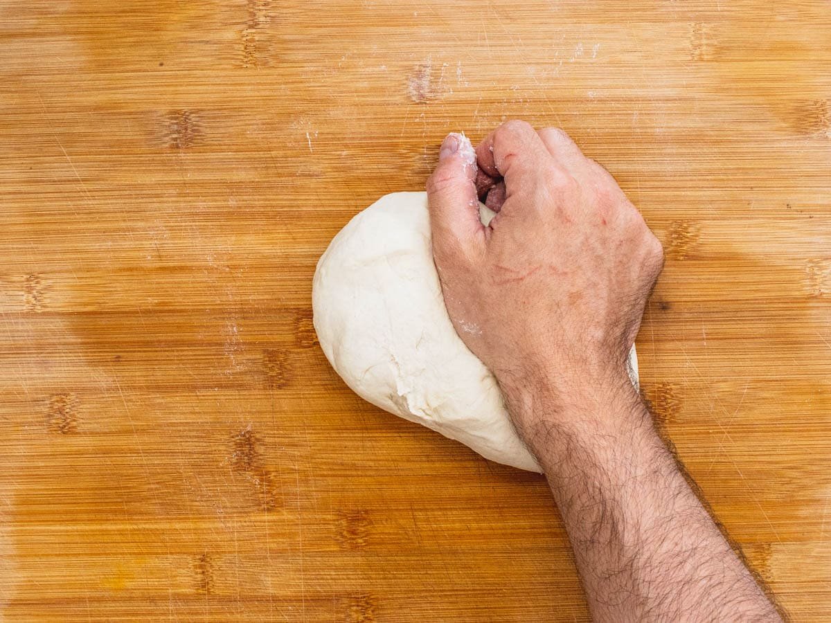 hand kneading pizza dough