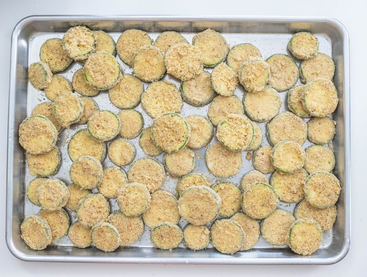 Zucchini on a baking tray before frying