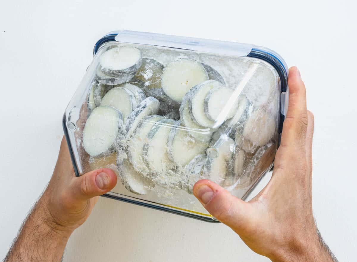 Zucchini in a box with hands