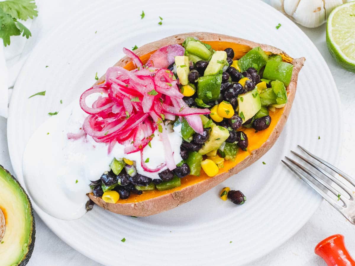 Microwave stuffed sweet potato with pickled red onion and black beans