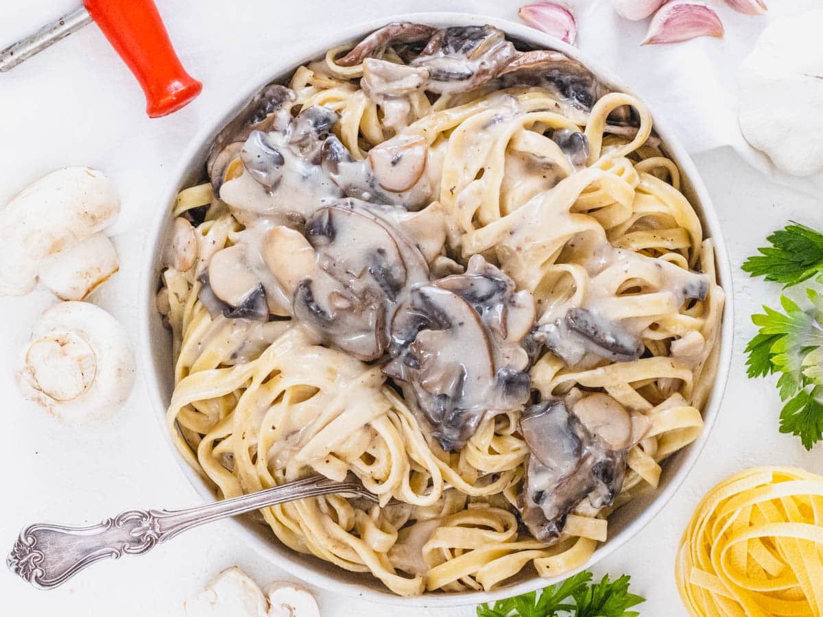 Mushroom Alfredo in a bowl with a fork