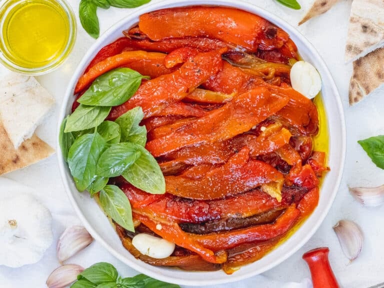 Roasted bell peppers in marinade with fresh basil