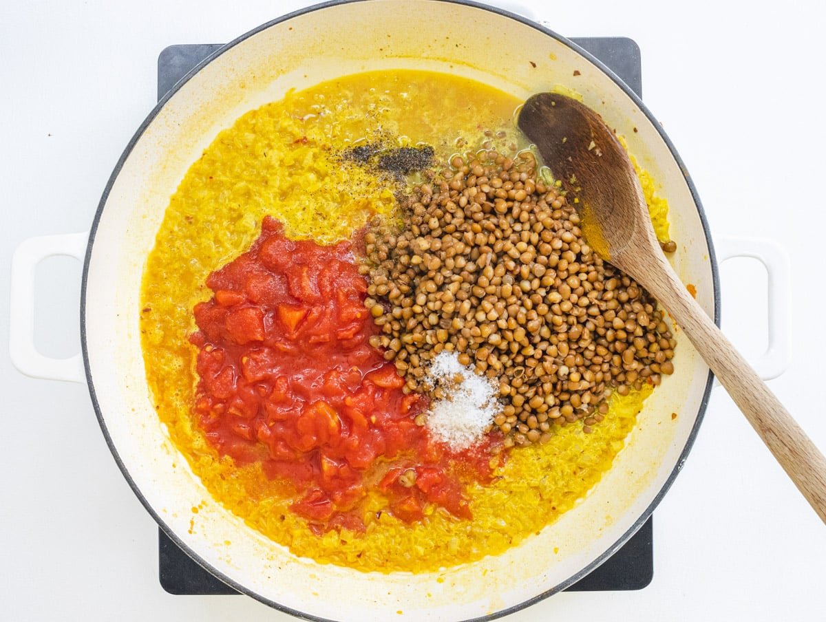 lentils and tomatoes in a skillet with rice