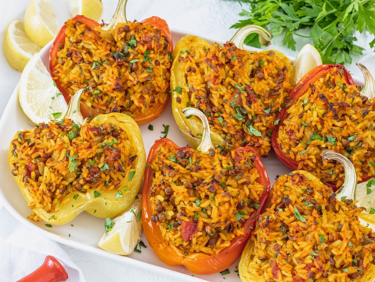 red and yellow stuffed bell peppers on a serving platter