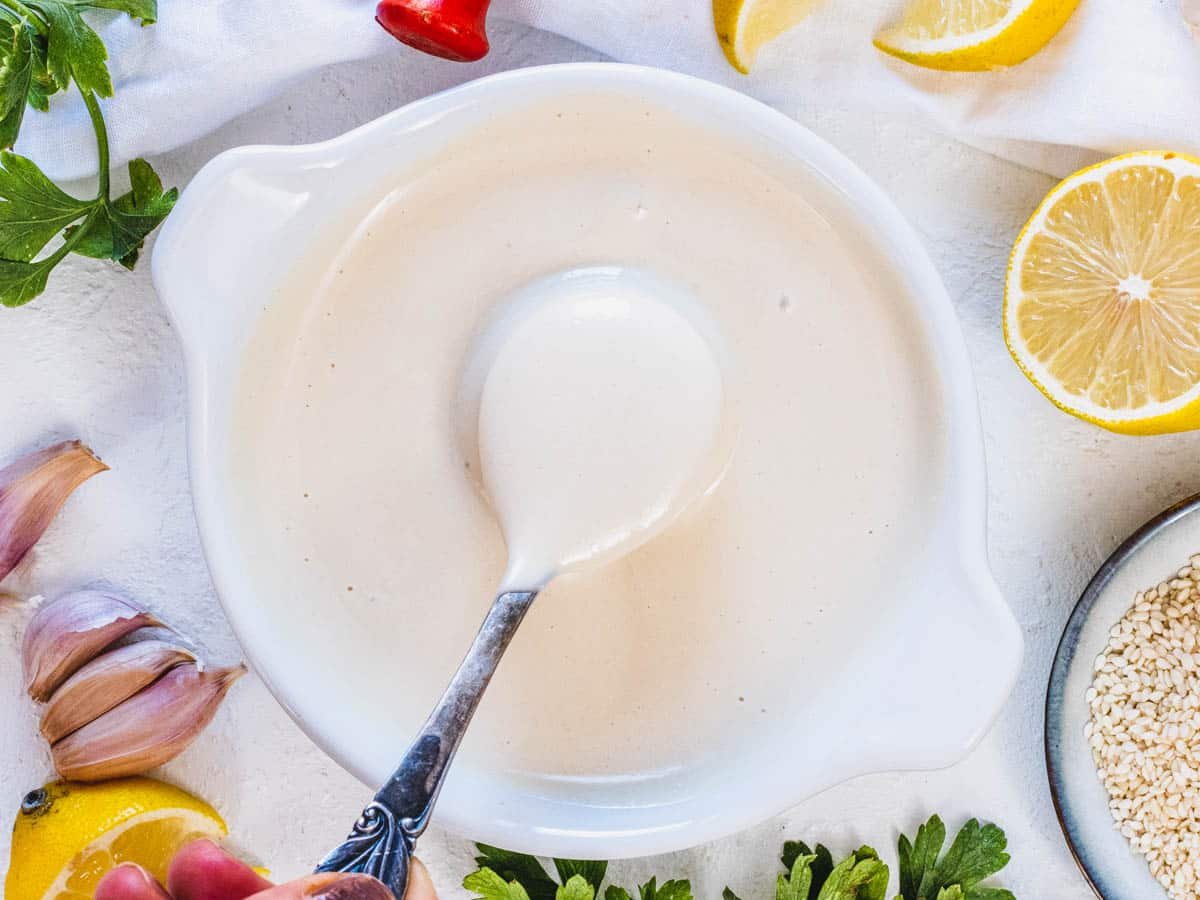 Tahini sauce with a spoon