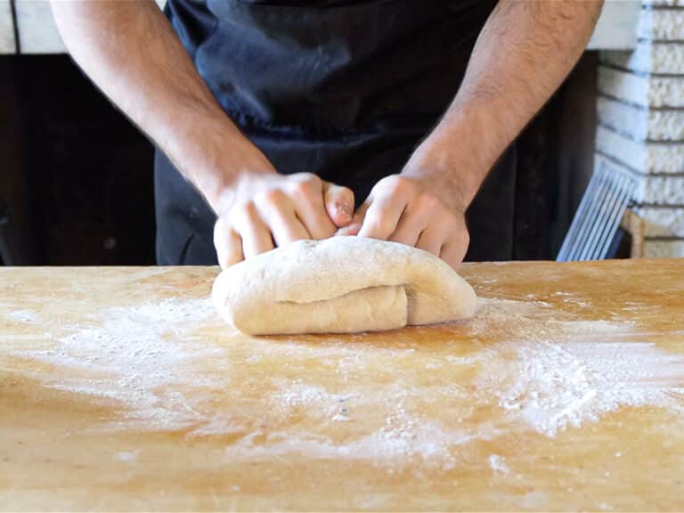 hands kneading vegan brioche dough