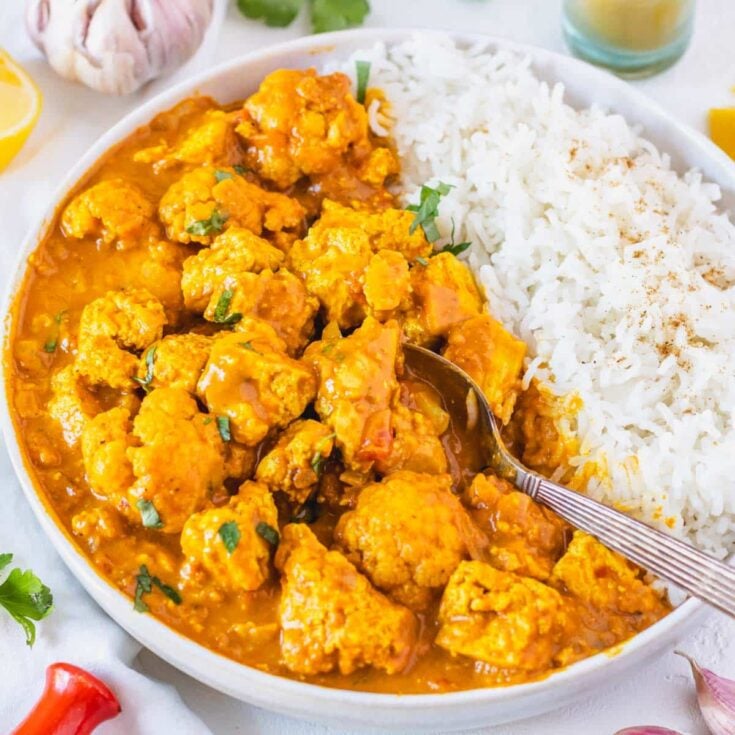 tofu curry with white rice and a spoon