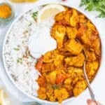 vegan curry in a bowl with rice and non-dairy yogurt