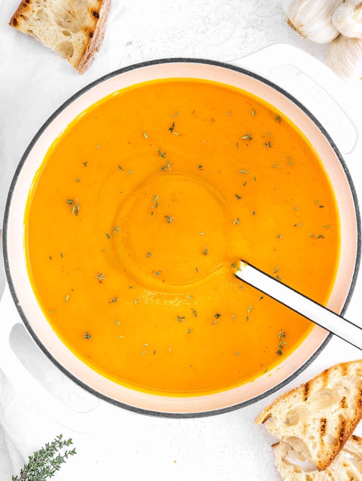 Butternut soup in a pot with toasted bread
