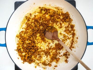 spices toasting in a blue skillet