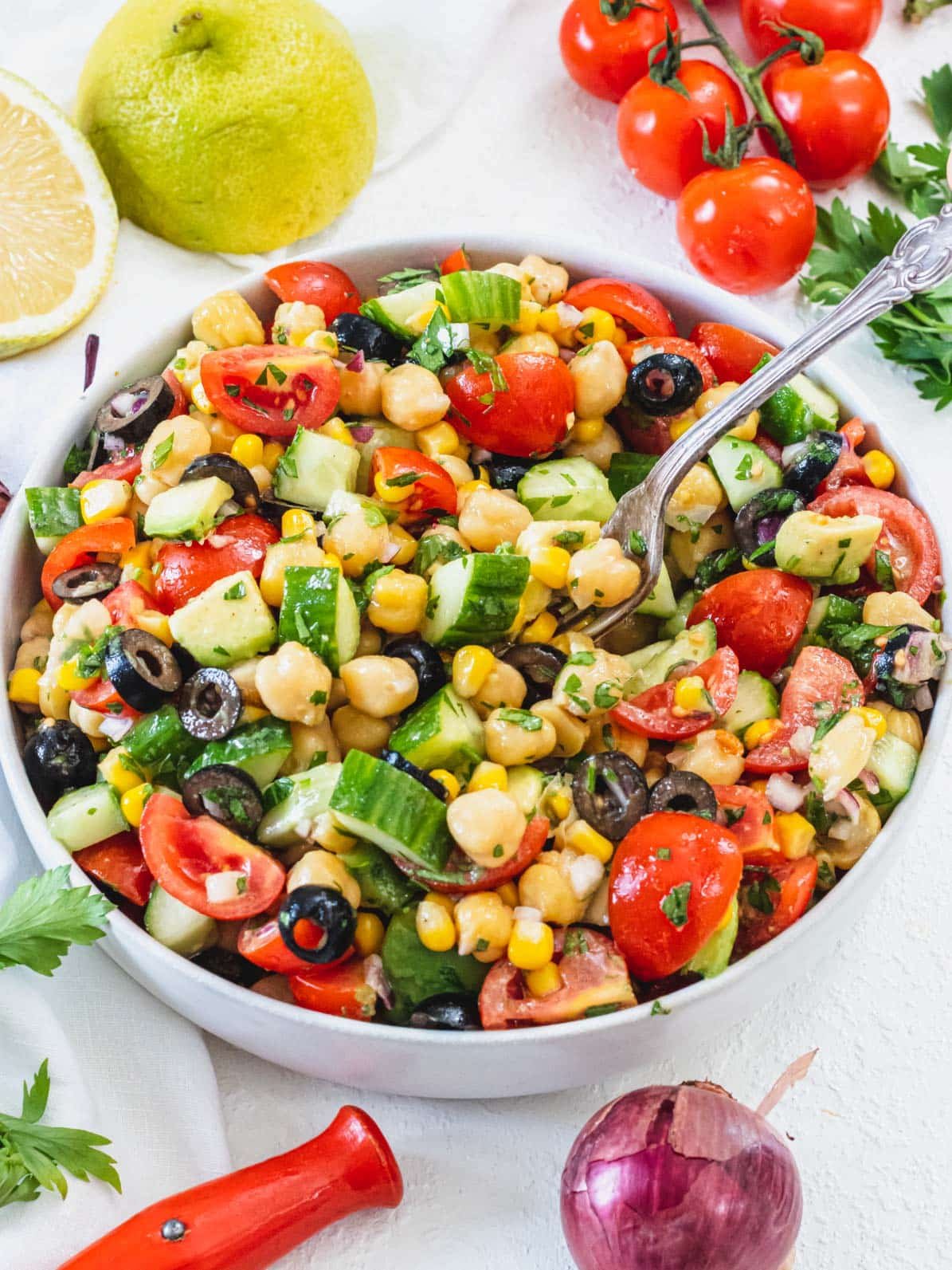 Chickpea salad with a silver fork and tomatoes