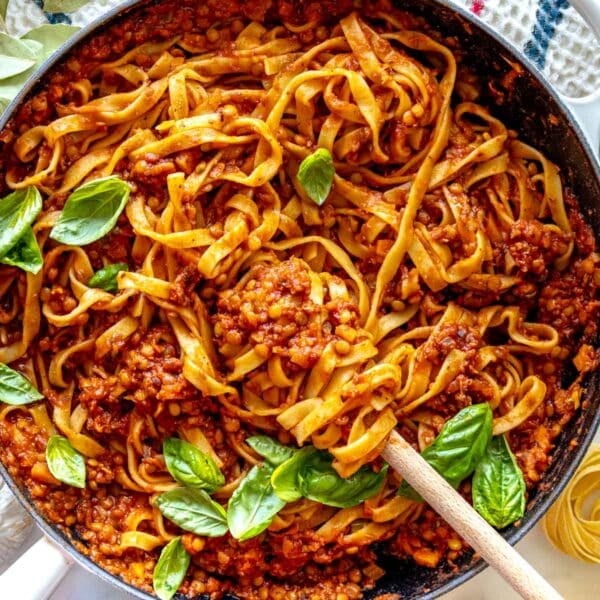 Lentil Bolognese in a skillet with fresh basil