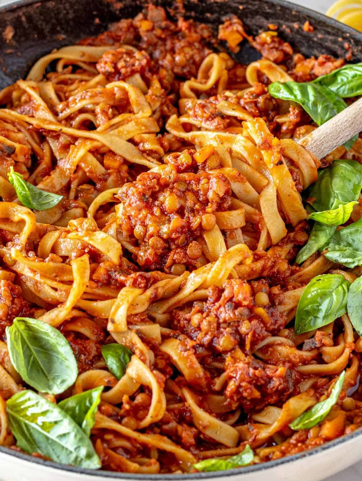 Lentil Bolognese with fresh basil in a pot