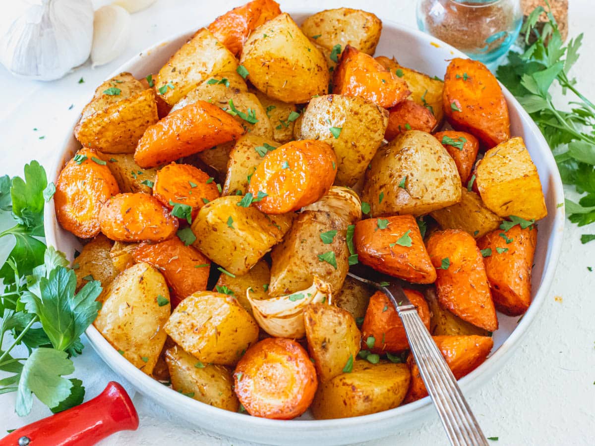 Roasted carrots and potatoes after baking in a bowl