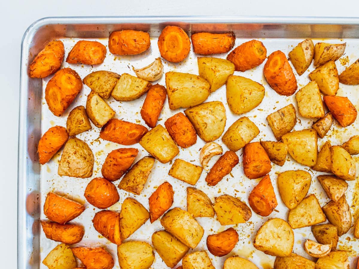 roasted carrots and potatoes on a baking tray