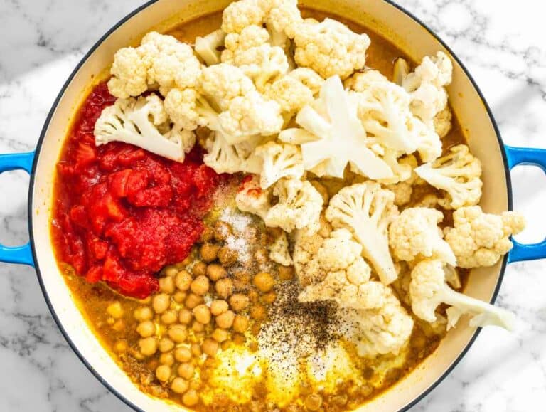 Step 3 Cauliflower and chickpeas simmering in creamy tomato coconut curry sauce.