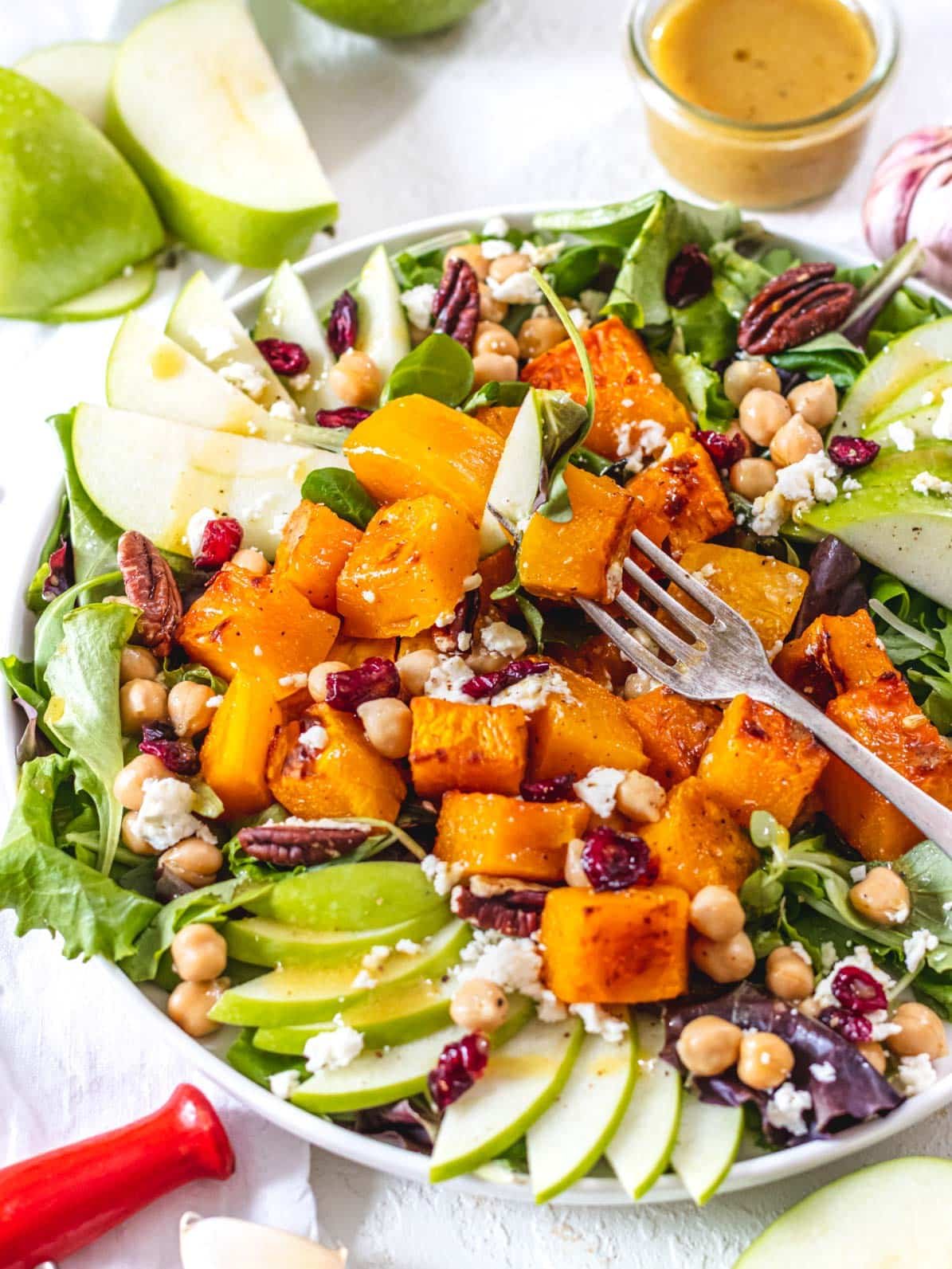 butternut squash salad on a plate with a fork