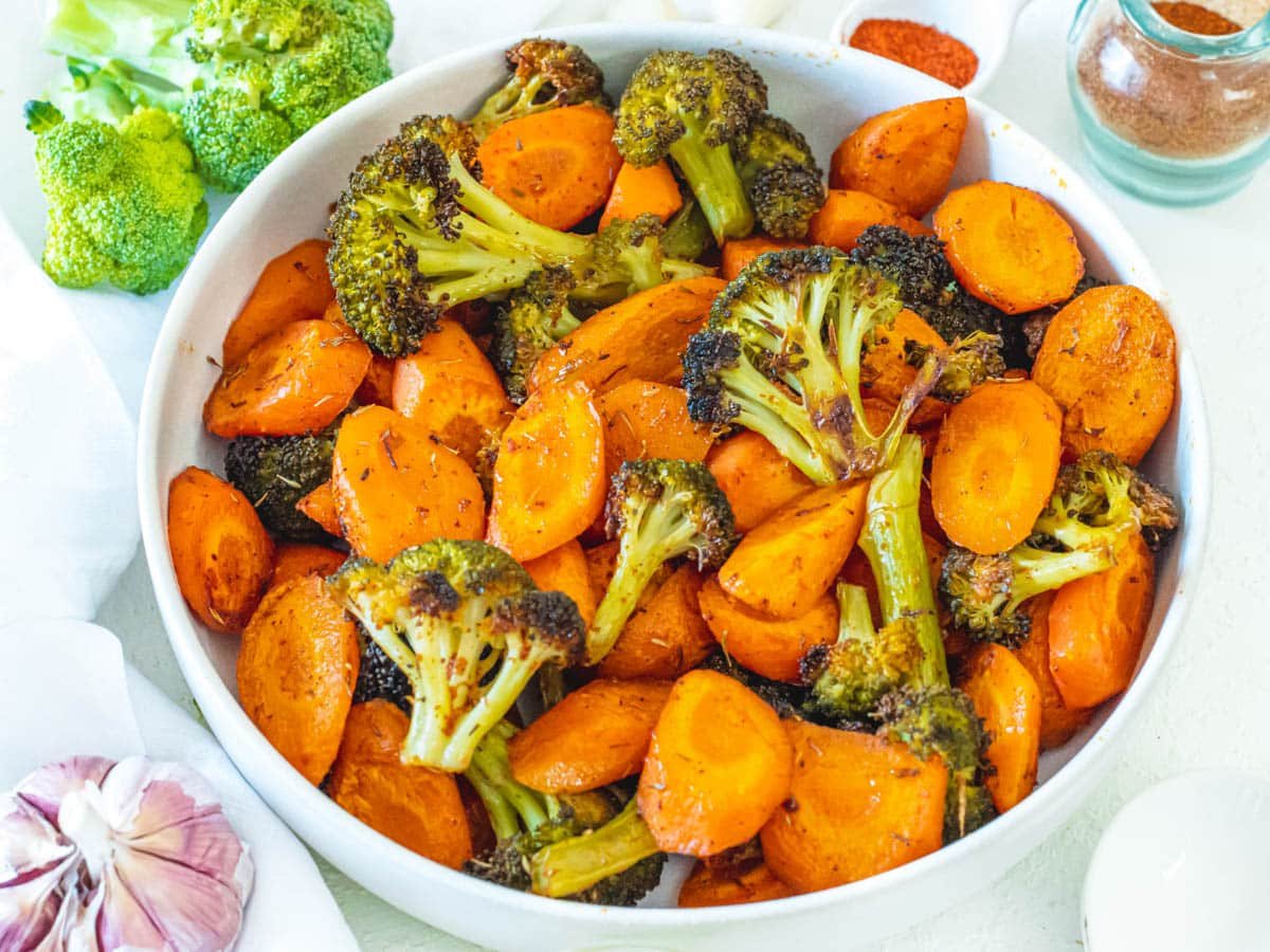 roasted carrots and broccoli in a white bowl
